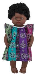 Plastic doll of a baby girl with dark curly hair wearing an Aboriginal print dress